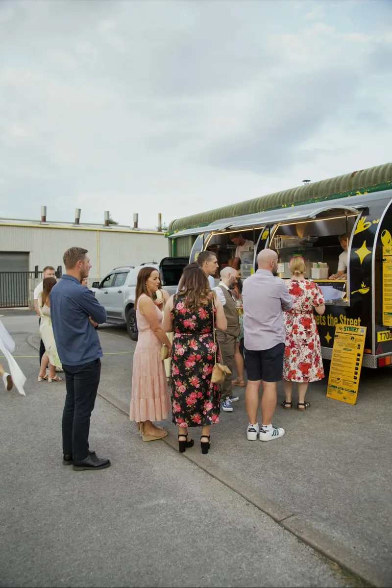 Guests queuing at the STREET van hatch at a private party